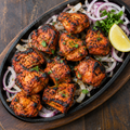 Grilled tandoori chicken tikka with onions and lemon